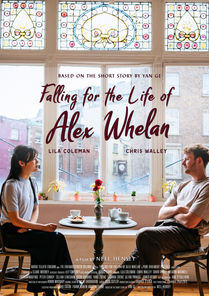A Chinese woman sitting across from a white man at a café. They are sitting in front of a window which is ornate. Above them is the text 'Falling for the Life of Alex Whelan'