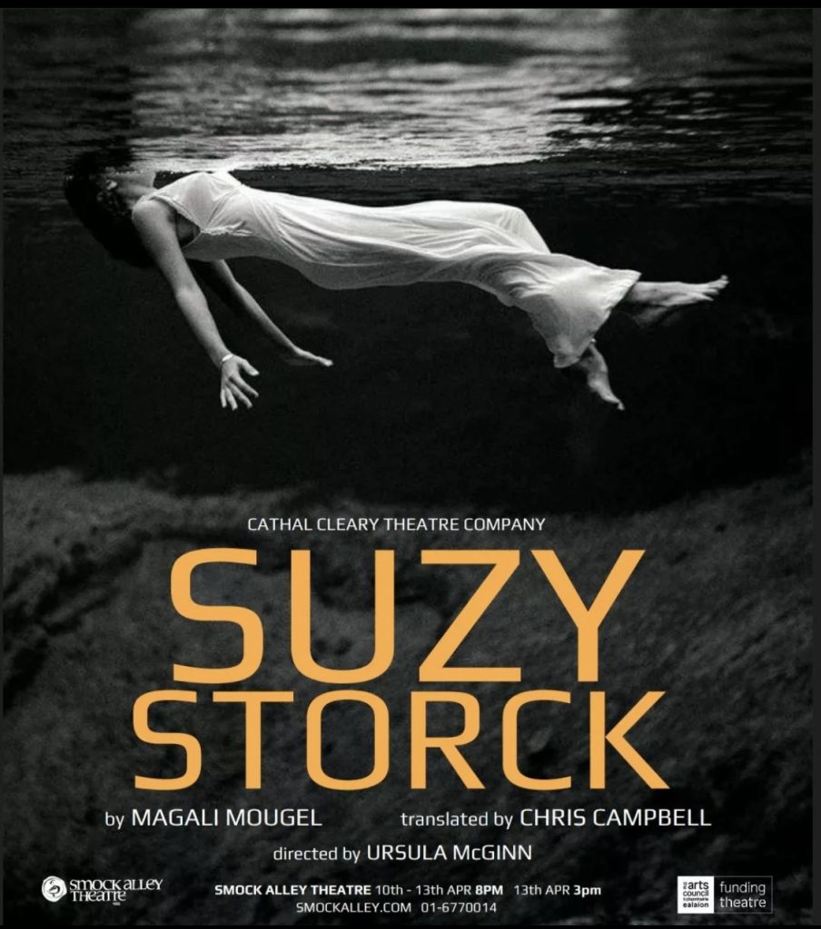 A poster of a woman underwater, wearing a white night dress. The words Suzy Storck are underneath her in yellow.